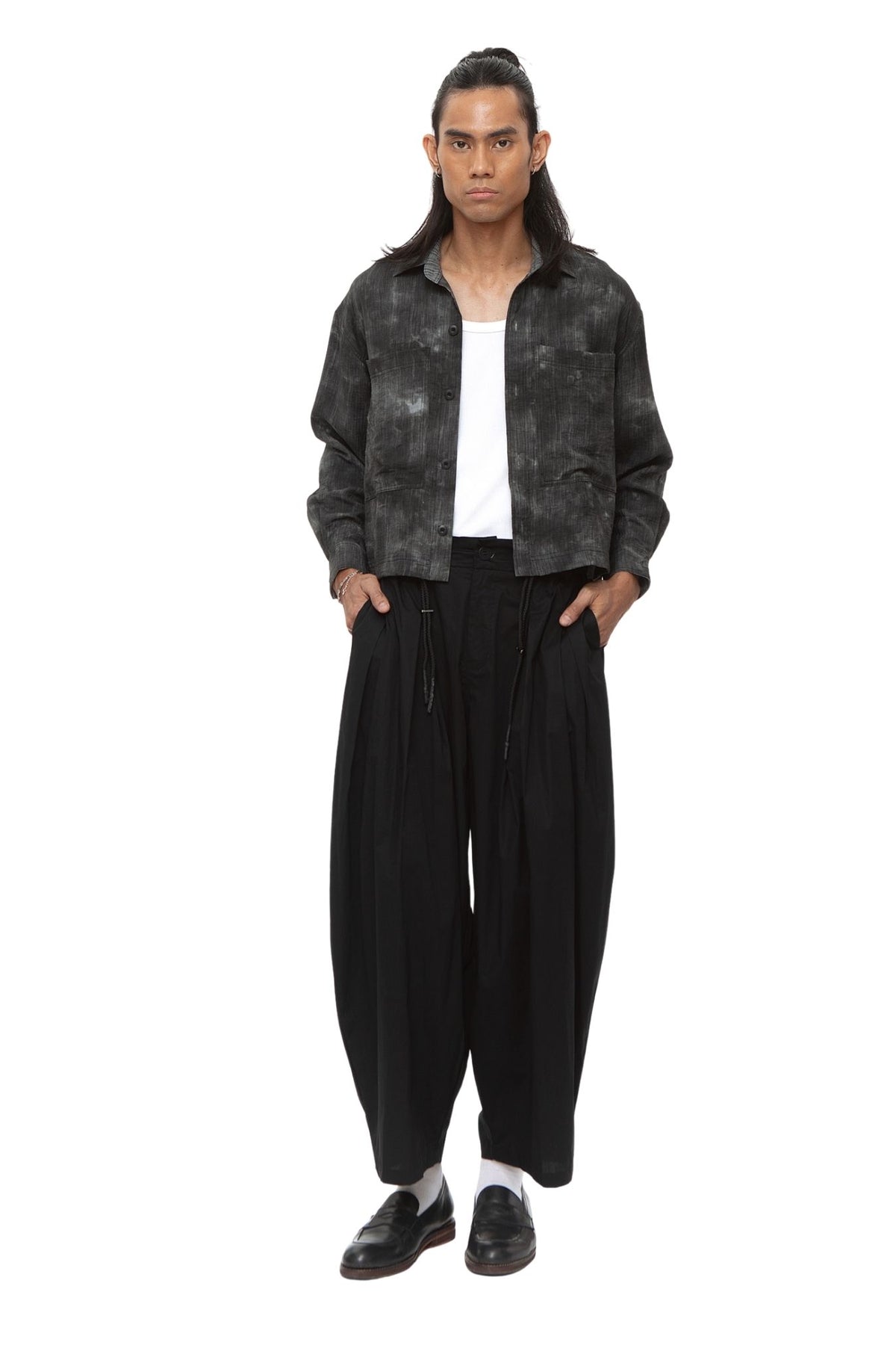 Model wearing cropped black cloud-wash shirt jacket open over a white tank top.